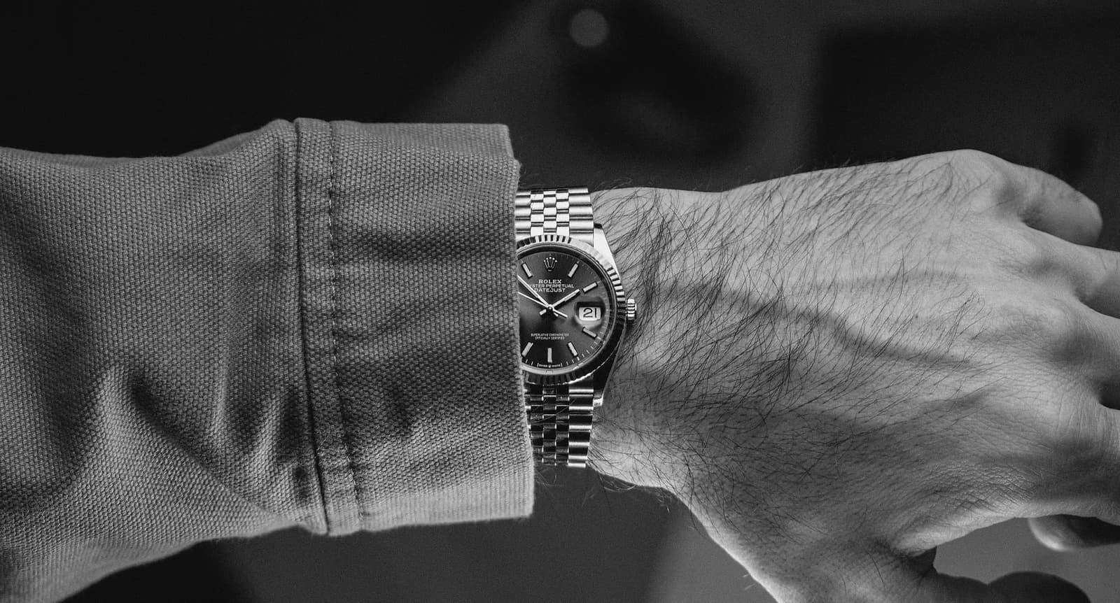 A Rolex Datejust on a Jubilee bracelet, photographed in black and white
